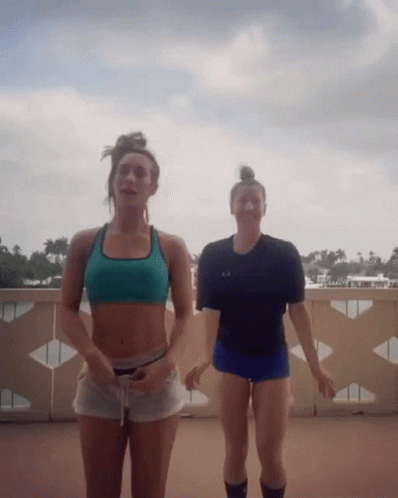 Two Women on Balcony One in Black Under Armour