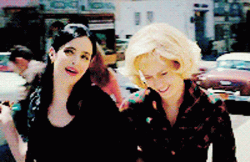 Two Women on Street, One Smoking