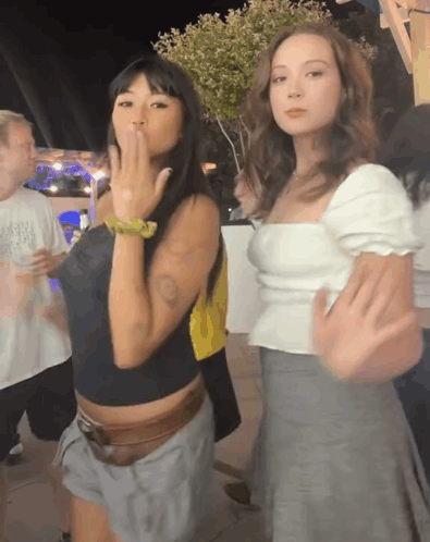 Two Women One Blowing a Kiss