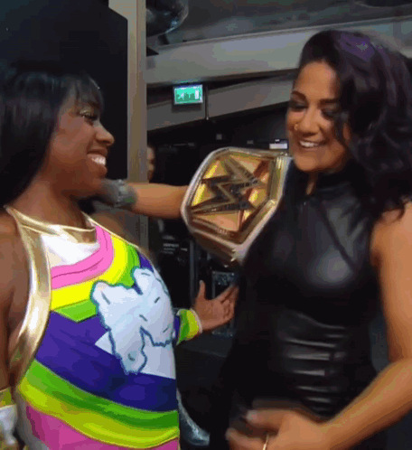 Two Women One Holding Championship Belt
