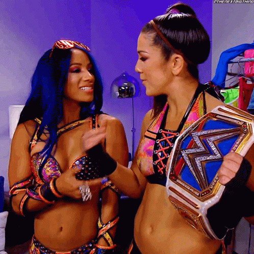 Two Women One Holding Championship Belt