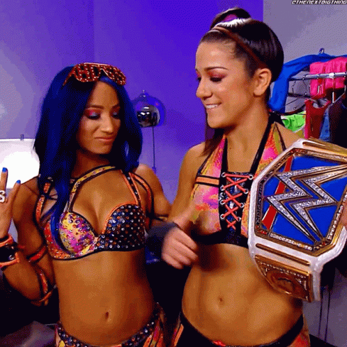 Two Women One Holding Wrestling Championship Belt