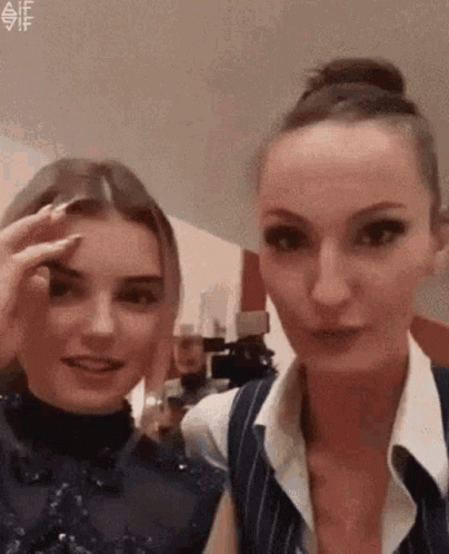 Two Women One Touching Eyebrow