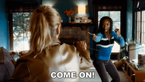 Two Women Playing Video Game Saying Come On