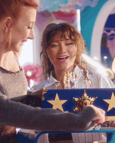 Two Women Playing With Blue Box Gold Stars
