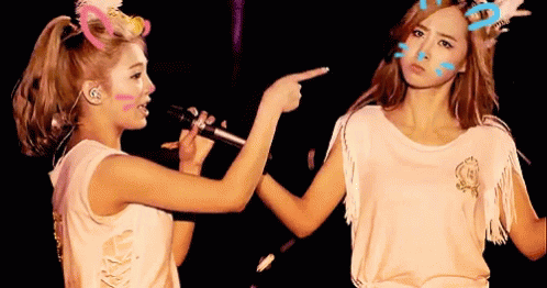 Two Women Pointing at Face