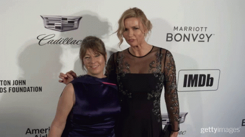 Two Women Pose On Red Carpet With Cadillac And Marriott Bonvoy Logo GIF