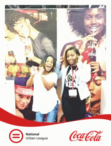 Two Women Posing in Front of Coca Cola Ad