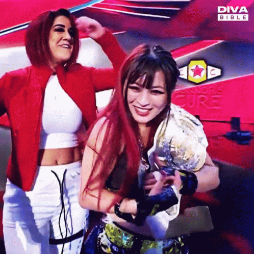 Two Women Posing in Front of Diva Bible Ad