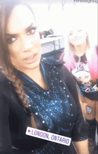Two Women Posing, One Has London Ontario Tag