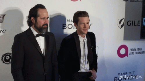 Two Women Posing Red Carpet With Cadillac Marriott GIF