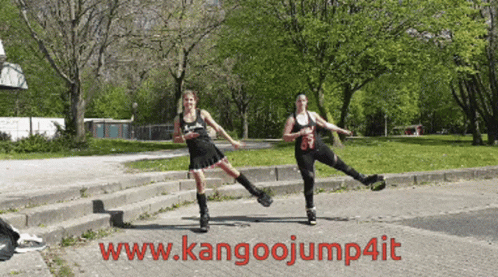 Two Women Rollerblading In A Park With The Website Www.kangoojump4it In The Corner GIF