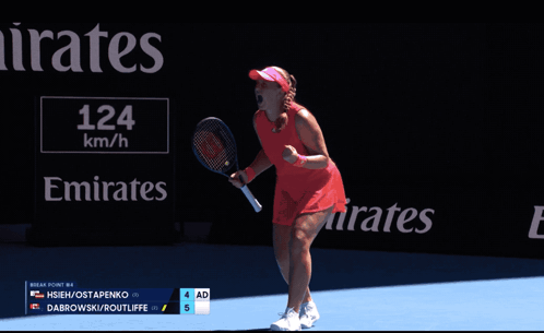 Two Women Shaking Hands on Tennis Court in Front of Emirates