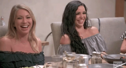 Two Women Sit At A Table With Bravo Written On The Bottom Of The Screen GIF