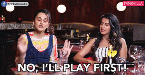 two women sitting at a table with the words no i 'll play first