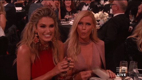 Two Women Sitting At Live Sign GIF