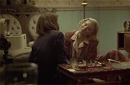 Two Women Sitting at Table Talking