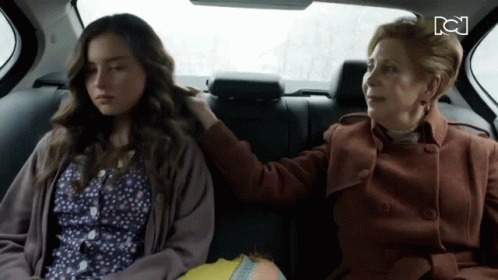Two Women Sitting in Back Seat of Car With CN Logo
