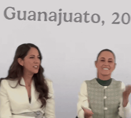Two Women Sitting in Front of Guanajuato Sign