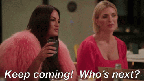 Two Women Sitting Keep Coming Who's Next GIF