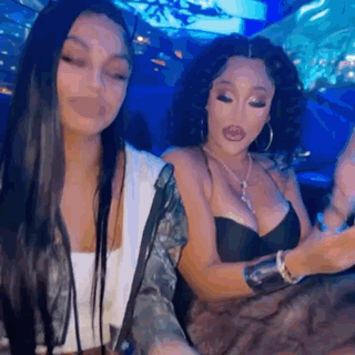 Two Women Sitting Next To Each Other In Restaurant GIF