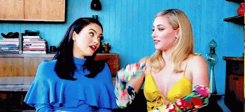 Two Women Sitting Next To Each Other Talking GIF