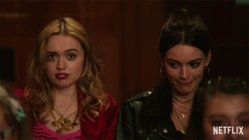 Two Women Sitting Next To Each Other With A Netflix Logo On The Bottom Right GIF