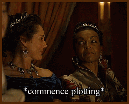 Two Women Sitting Next To Each Other With The Words Commence Plotting Written Below Them GIF