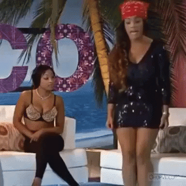 Two Women Sitting on Couch One With Bandana