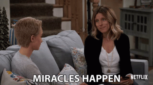 Two Women Sitting on Couch Saying Miracles Happen