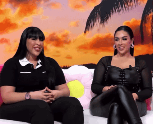 Two Women Sitting on Couch Smiling