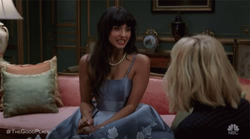 Two Women Sitting On Pink Couch Talking GIF