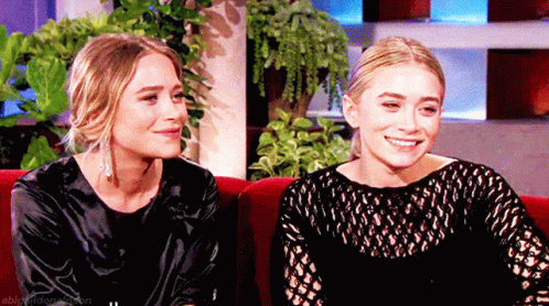 Two Women Sitting on Red Couch