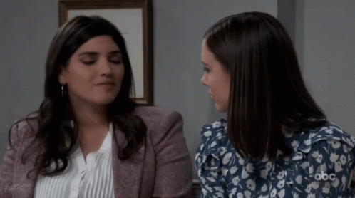 Two Women Sitting, One With ABC Logo