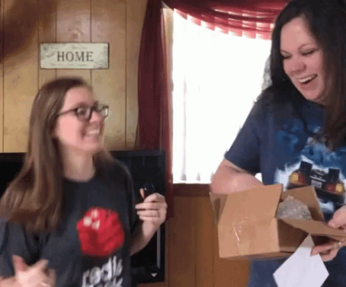 Two Women Smiling at Home Sign