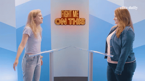Two Women Stand In Front Of A Sign That Says " Fight Me On This " GIF