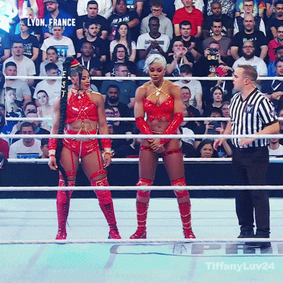 Two Women Standing In A Boxing Ring With A Crowd In The Background And The Words Lyon France On The Bottom GIF