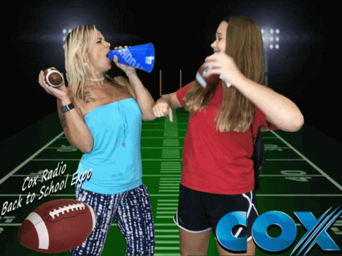 Two Women Standing In Front Of A Football Field With Cox Radio Written On The Bottom GIF