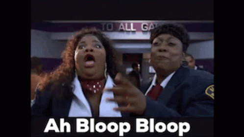 Two Women Standing In Front Of Sign GIF