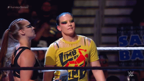 Two Women Standing in Wrestling Ring