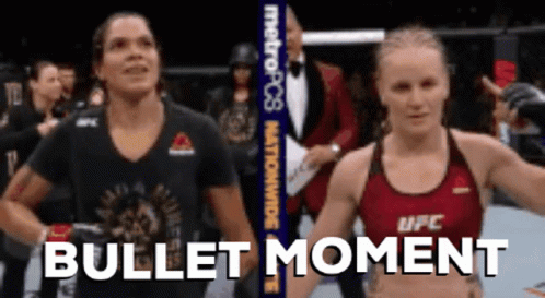 Two Women Standing Next to Each Other Bullet Moment