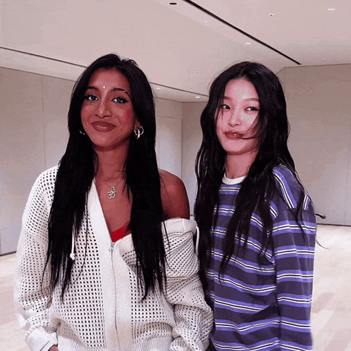 Two Women Standing Next to Each Other