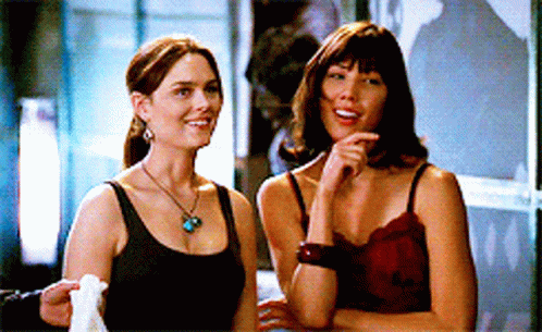 Two Women Standing Next to Each Other