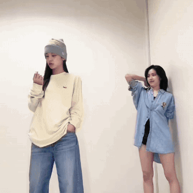 Two Women Standing Next To Each Other With One Wearing A Sweater With A Lacoste Logo On It GIF
