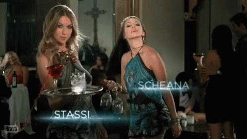 Two Women Standing Next To Each Other With The Name Stassi And Scheana GIF