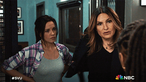 Two Women Standing Next To Each Other With The Nbc Logo On The Bottom Right GIF