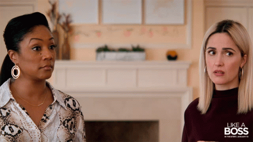 Two Women Standing Next To Each Other With The Words Like A Boss In The Background GIF