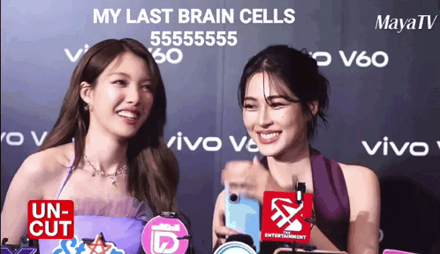 Two Women Standing Next To Each Other With The Words My Last Brain Cells Written On The Wall Behind Them GIF