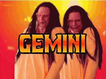 Two Women Standing Next to Gemini Word