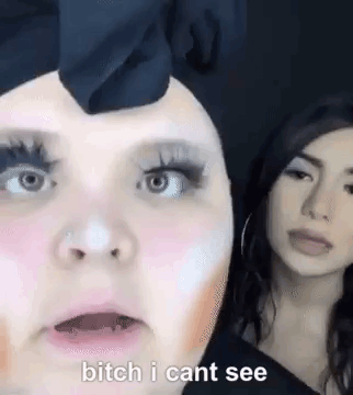Two Women Standing Side By Side One Wearing Makeup